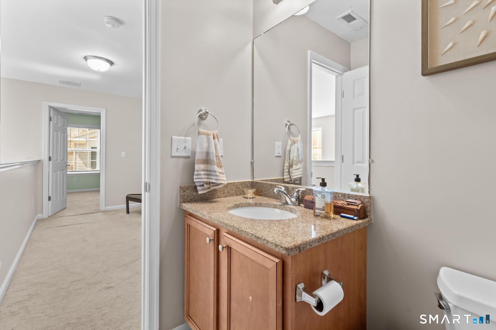 5 Haskins Road, Unit 5 Windsor, CT 06095 - Photo 37 of 40 a bathroom with a granite countertop sink and a mirror