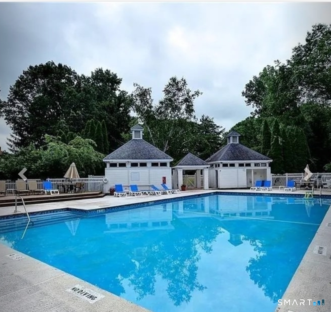 5 Haskins Road, Unit 5 Windsor, CT 06095 - Photo 5 of 40 a front view of a house with swimming pool and next to trees