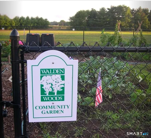 a sign that is on the side of a park next to a lake