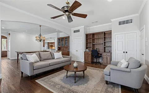 a living room with furniture a rug and a chandelier