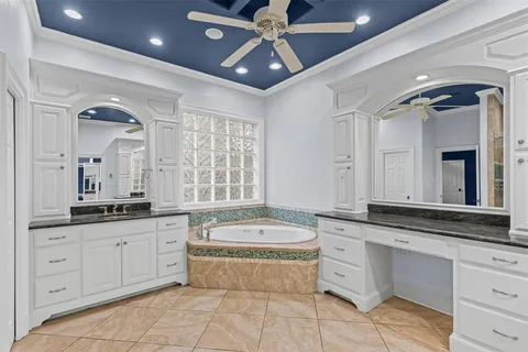 a spacious bathroom with a granite countertop tub sink and mirror