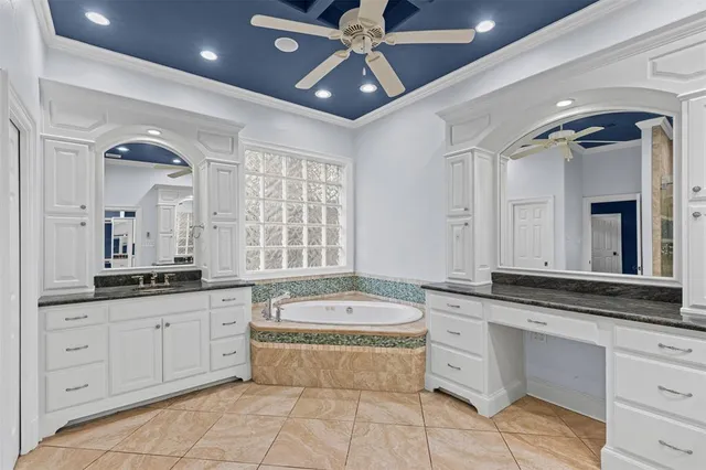 a spacious bathroom with a granite countertop tub sink and mirror