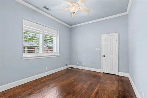 a view of a room with wooden floor and a window