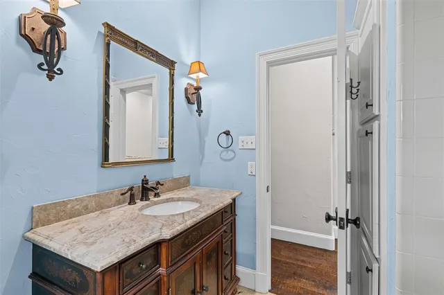 a bathroom with a granite countertop sink and a mirror