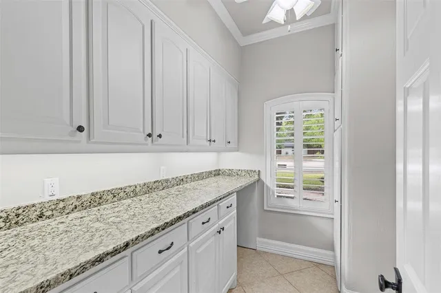 a kitchen with granite countertop white cabinets and sink