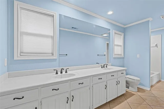 a bathroom with a double vanity sink a mirror and a