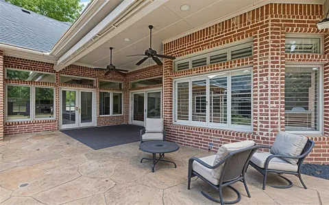 a view of a patio with couple of chairs