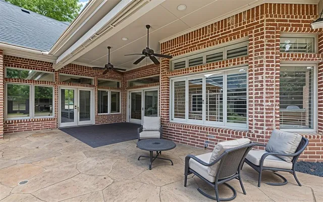 a view of a patio with couple of chairs