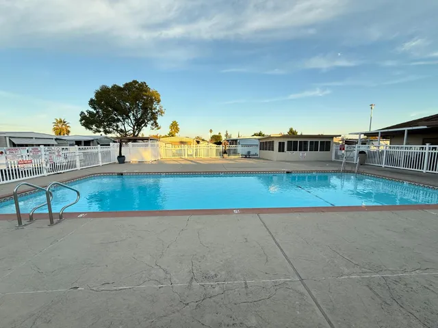 a view of a swimming pool and an outdoor seating