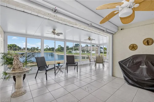 a dining room with furniture and a floor to ceiling window
