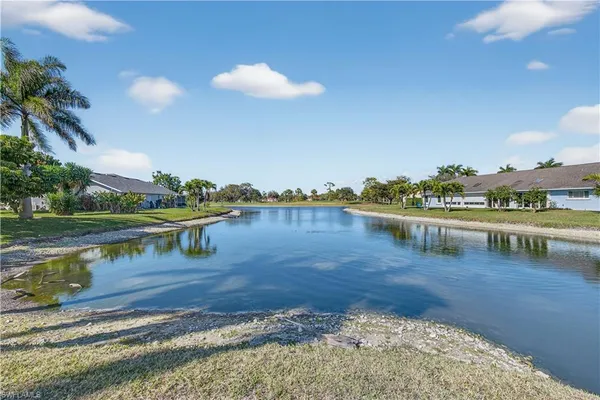 a view of a lake with houses in the background
