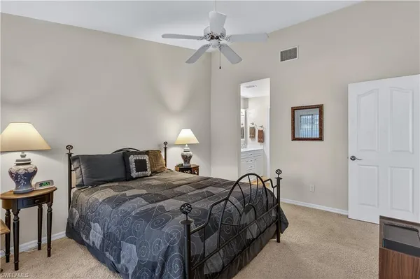 a bedroom with a bed and a ceiling fan