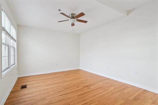 683 Main Street, Unit 22 Hackensack, NJ 07601 - Photo 8 of 15 wooden floor in an empty room with a window