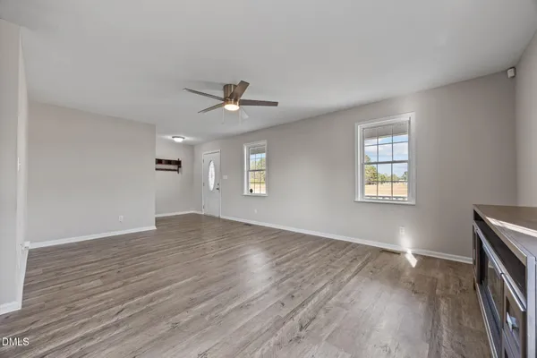 wooden floor in an empty room with a window