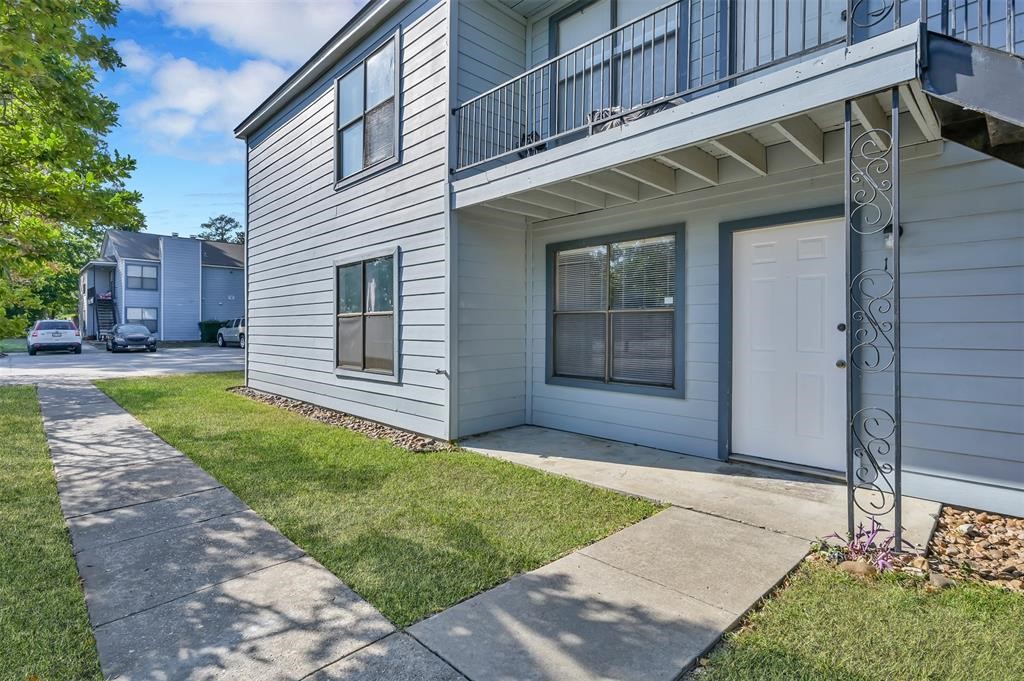 900 Holly Drive, Unit 13 Conroe, TX 77301 - Photo 2 of 12 a view of a house with a yard