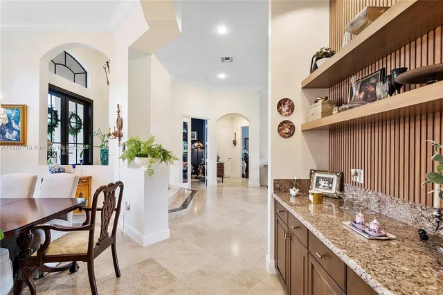 a view of a dining room with furniture large windows and wooden floor