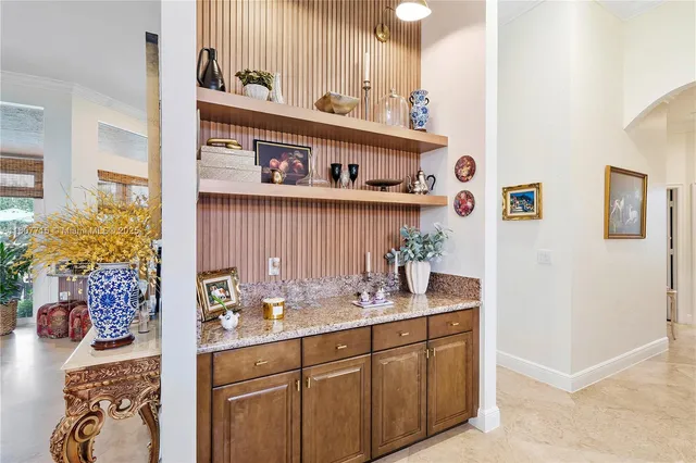a dining room with furniture a chandelier and wooden floor