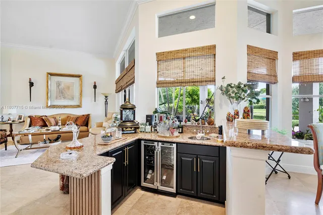a living room with furniture a flat screen tv and a large window