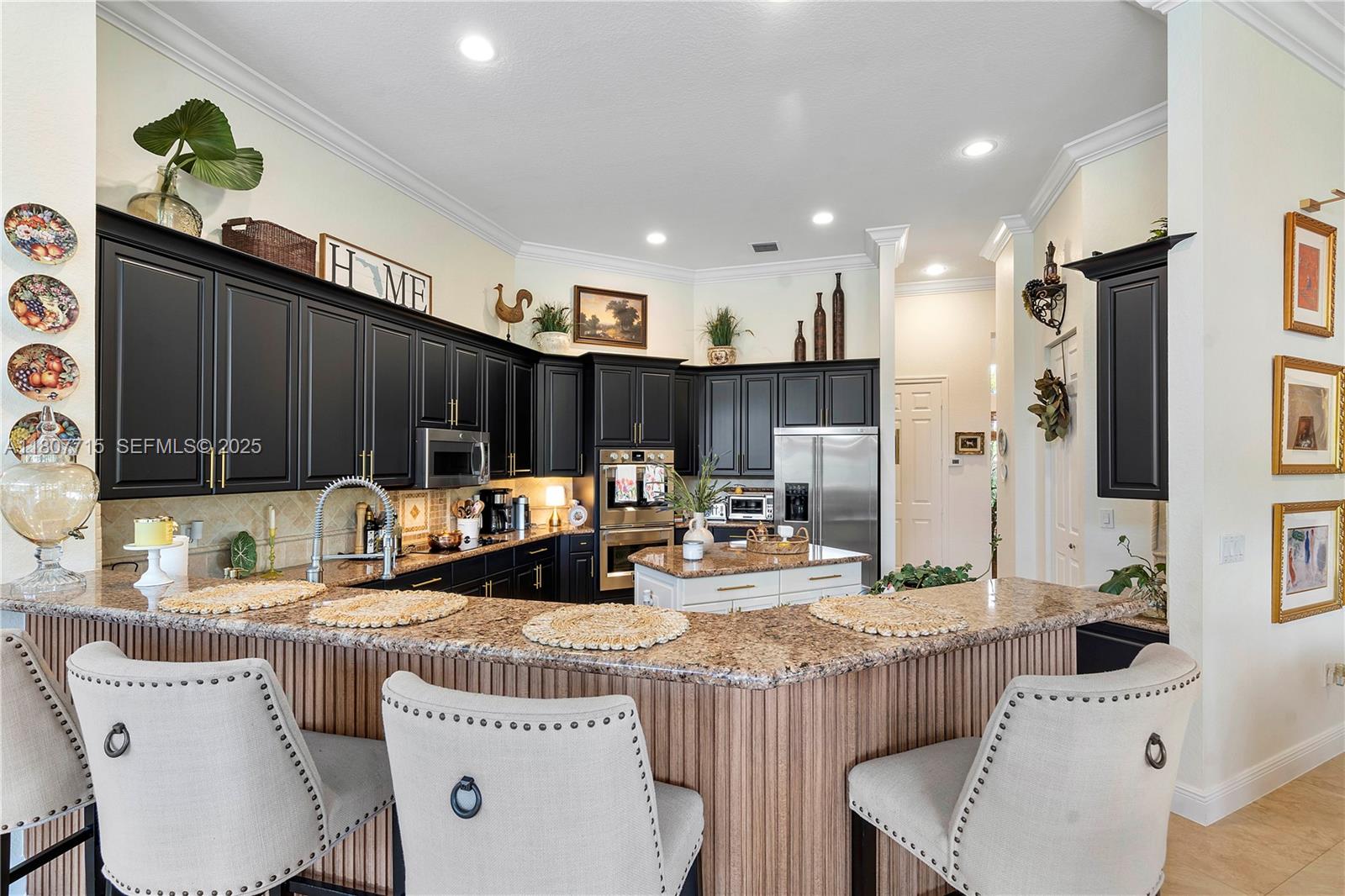 14933 Southwest 33rd Street Davie, FL 33331 - Photo 21 of 88 a kitchen with kitchen island granite countertop a sink and a refrigerator