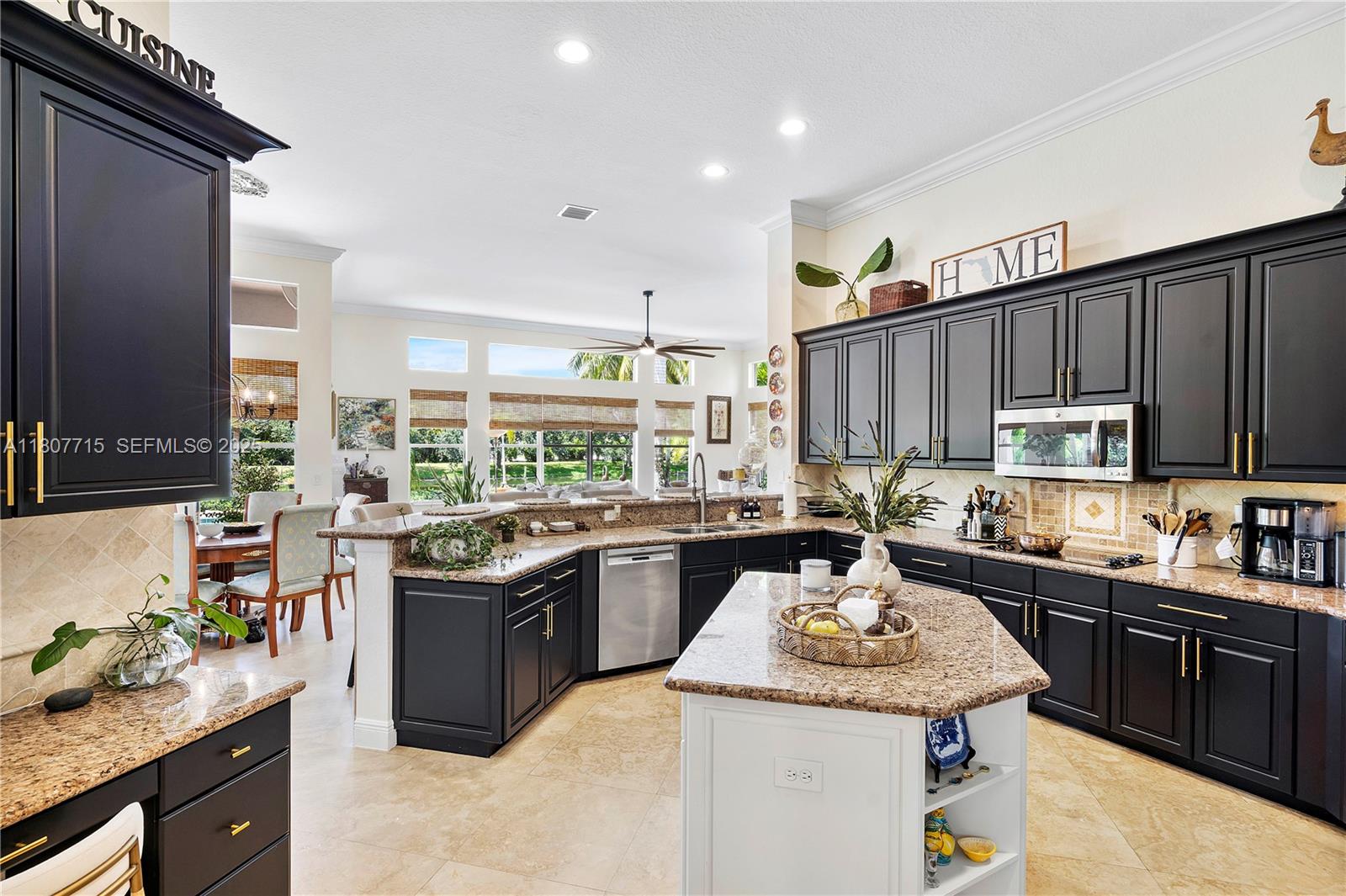 14933 Southwest 33rd Street Davie, FL 33331 - Photo 22 of 88 a kitchen with kitchen island granite countertop a sink counter top space appliances and cabinets