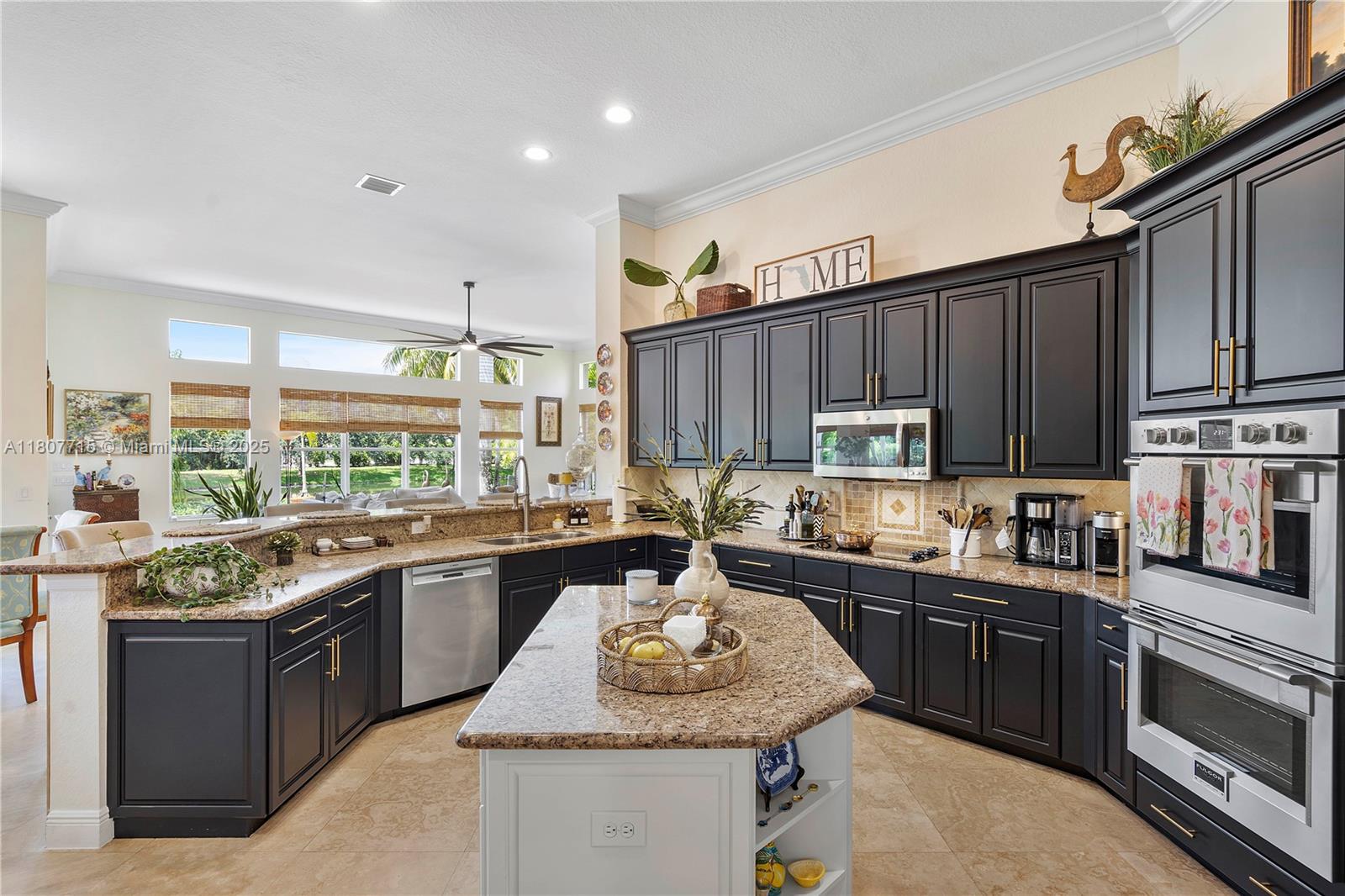 14933 Southwest 33rd Street Davie, FL 33331 - Photo 23 of 88 a kitchen with kitchen island granite countertop a sink stove and refrigerator