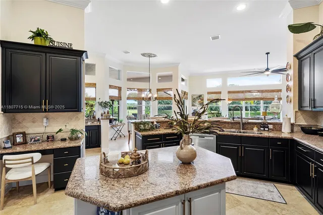 a large spacious bathroom with a granite countertop double vanity sink a large mirror a bathtub and next to a window