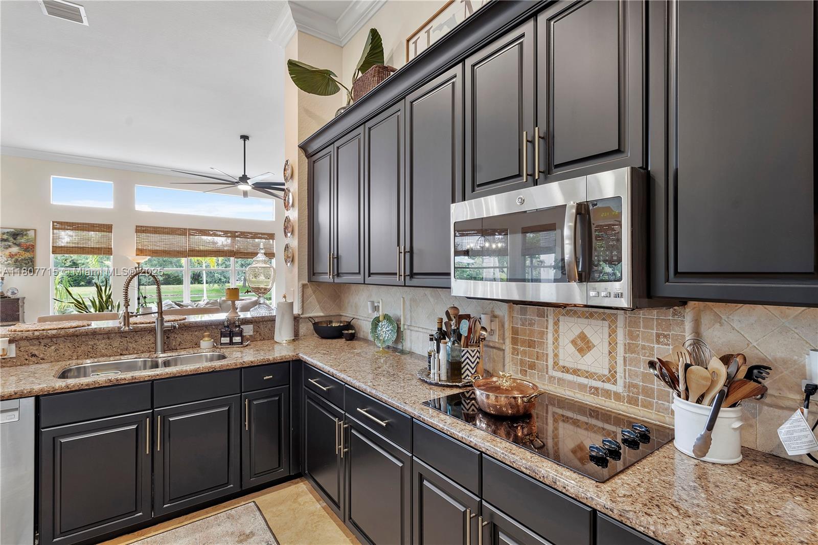 14933 Southwest 33rd Street Davie, FL 33331 - Photo 27 of 88 a kitchen with stainless steel appliances granite countertop a sink stove and cabinets