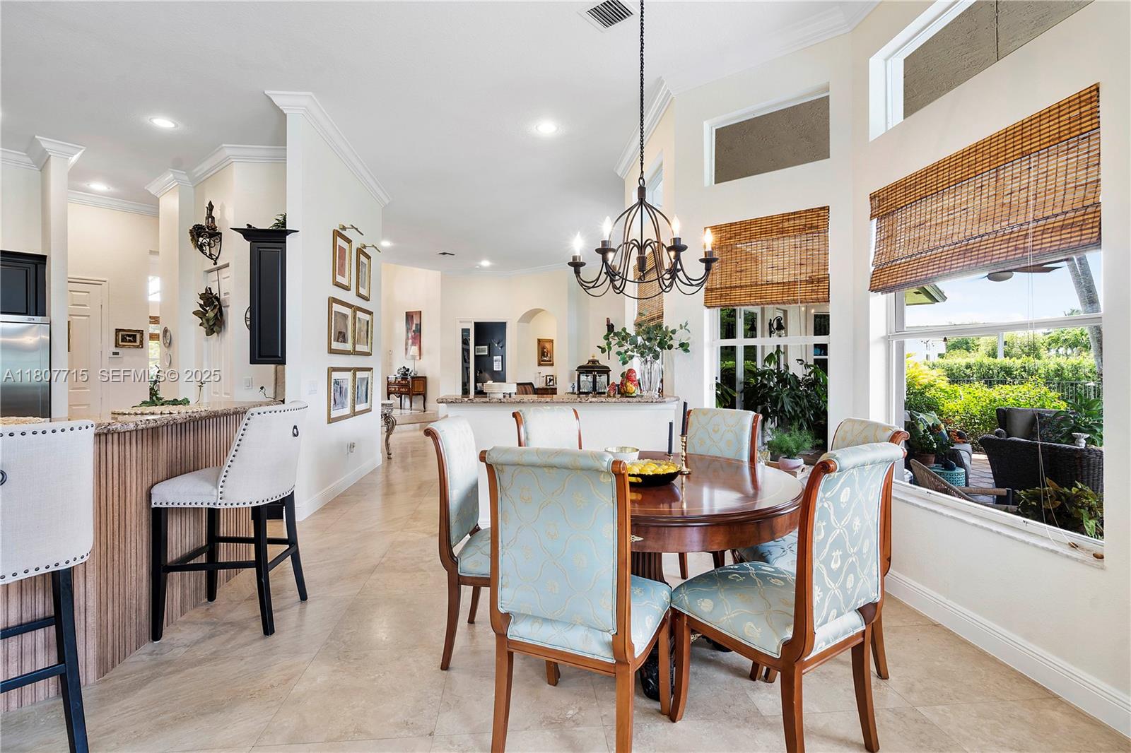 14933 Southwest 33rd Street Davie, FL 33331 - Photo 29 of 88 a dining room with furniture a chandelier and wooden floor