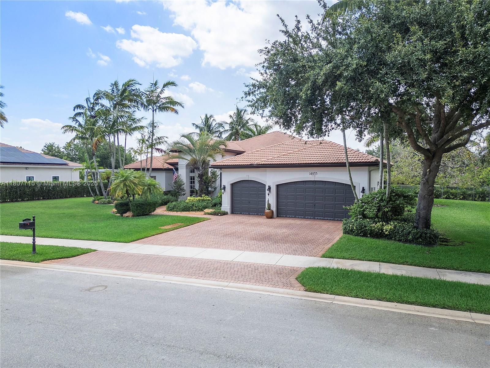 14933 Southwest 33rd Street Davie, FL 33331 - Photo 3 of 88 a front view of a house with a yard and garage
