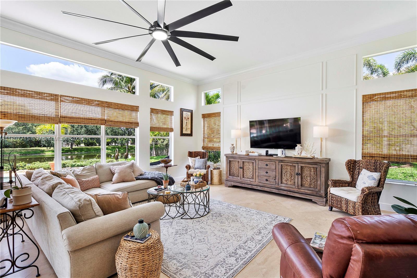 14933 Southwest 33rd Street Davie, FL 33331 - Photo 31 of 88 a living room with furniture a flat screen tv and a large window