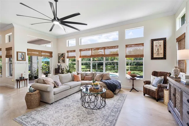 a living room with patio furniture and a garden