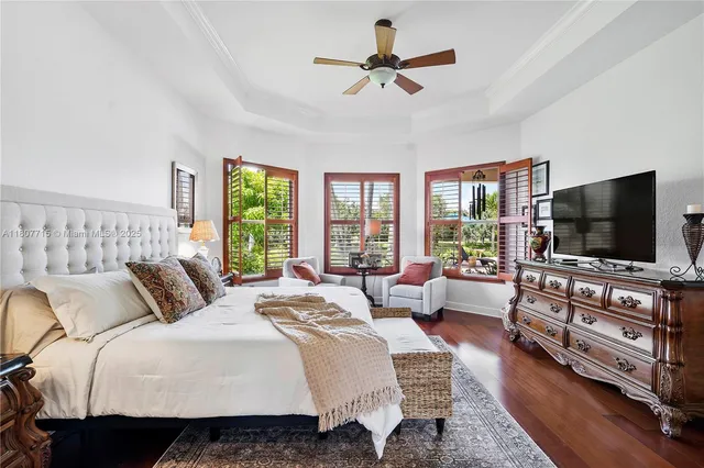 a view of house with a big yard and large trees