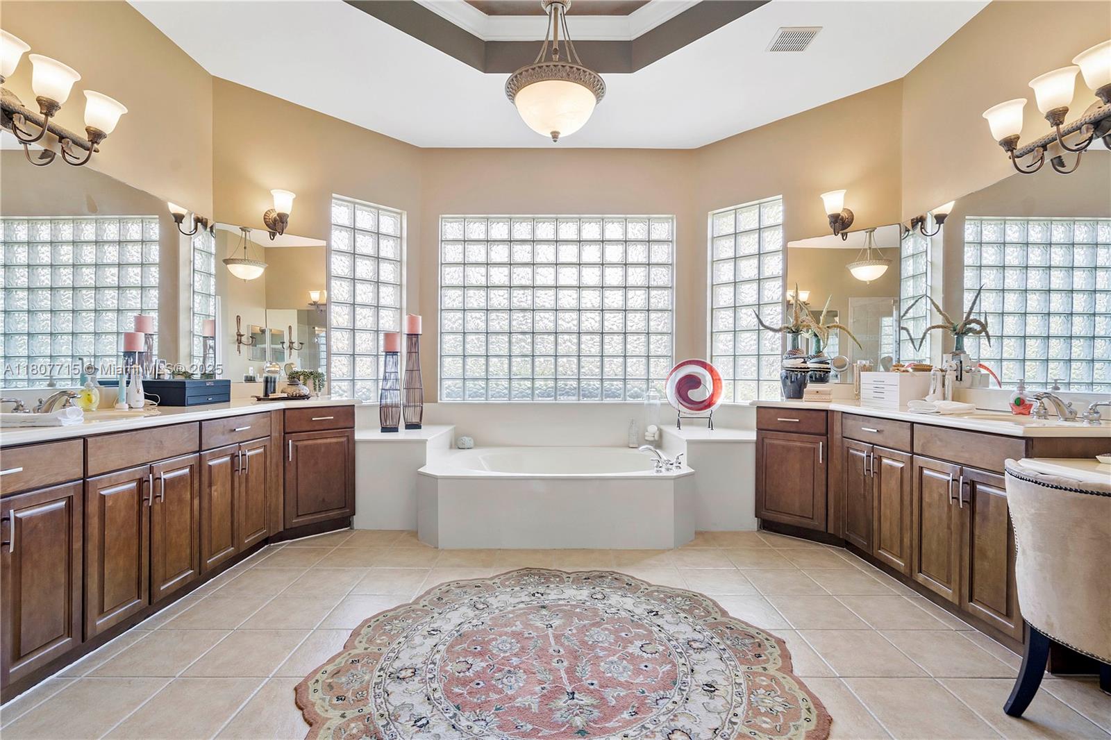 14933 Southwest 33rd Street Davie, FL 33331 - Photo 39 of 88 a large spacious bathroom with a granite countertop double vanity sink a large mirror a bathtub and next to a window