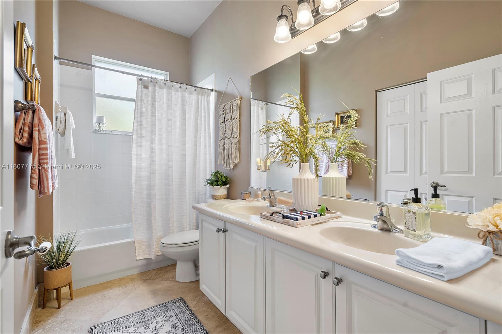 14933 Southwest 33rd Street Davie, FL 33331 - Photo 46 of 88 a bathroom with a granite countertop sink a toilet a mirror a vanity and shower