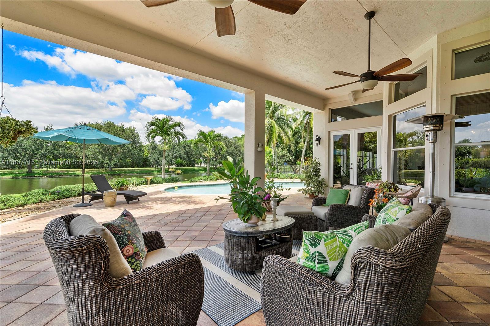 14933 Southwest 33rd Street Davie, FL 33331 - Photo 52 of 88 a living room with patio furniture and a garden