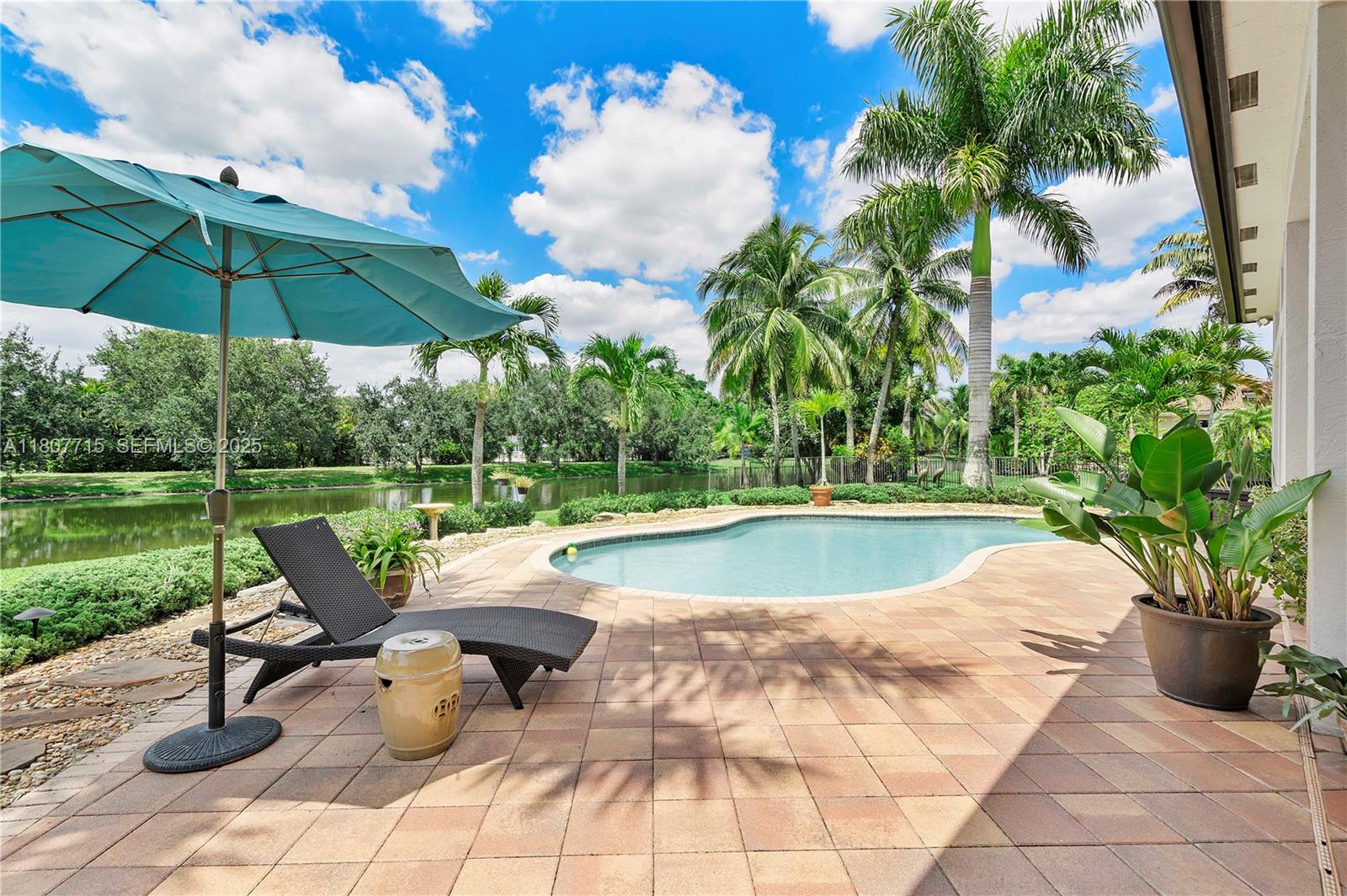 14933 Southwest 33rd Street Davie, FL 33331 - Photo 54 of 88 a view of a swimming pool with sitting area and furniture