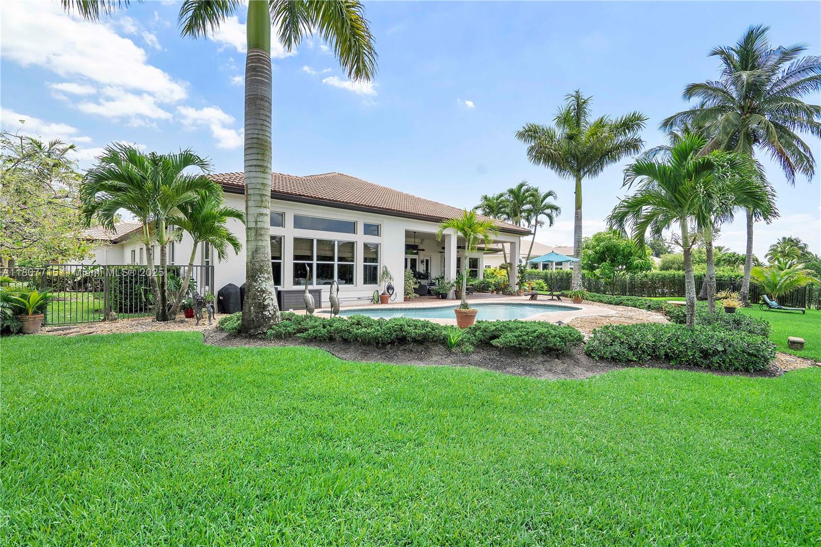 14933 Southwest 33rd Street Davie, FL 33331 - Photo 58 of 88 a view of a house with a big yard and palm trees