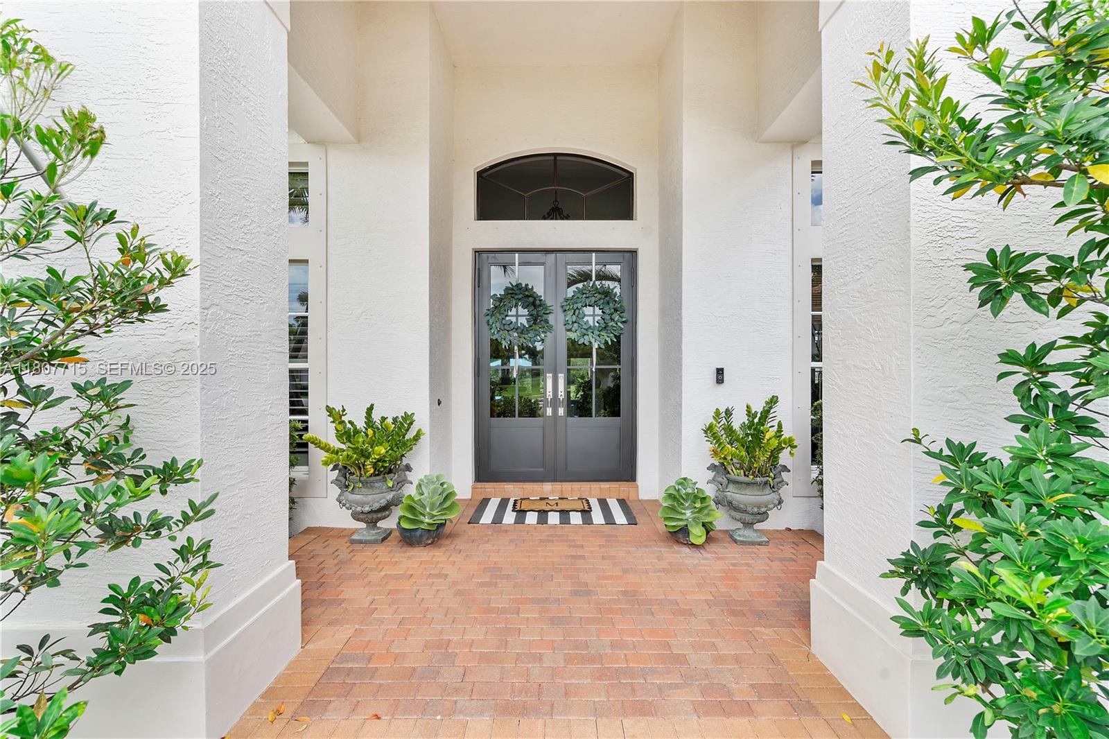 14933 Southwest 33rd Street Davie, FL 33331 - Photo 6 of 88 a potted plant sitting in front of a house with potted plants