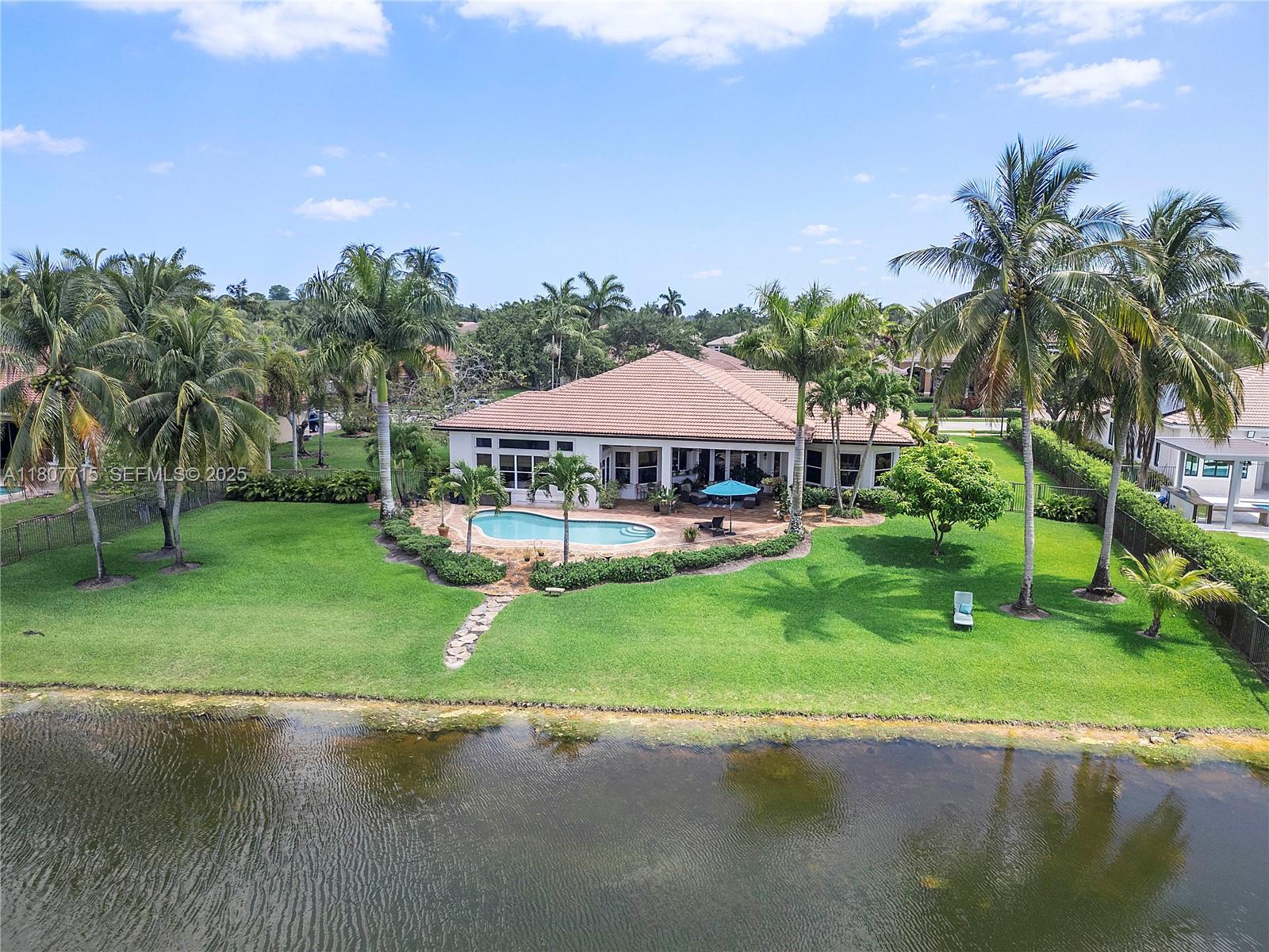 14933 Southwest 33rd Street Davie, FL 33331 - Photo 75 of 88 a view of a patio with a table and chairs under an umbrella