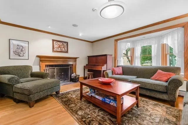 a living room with furniture a flat screen tv and a fireplace