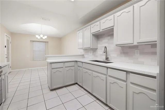 a kitchen with stainless steel appliances granite countertop a sink and a stove