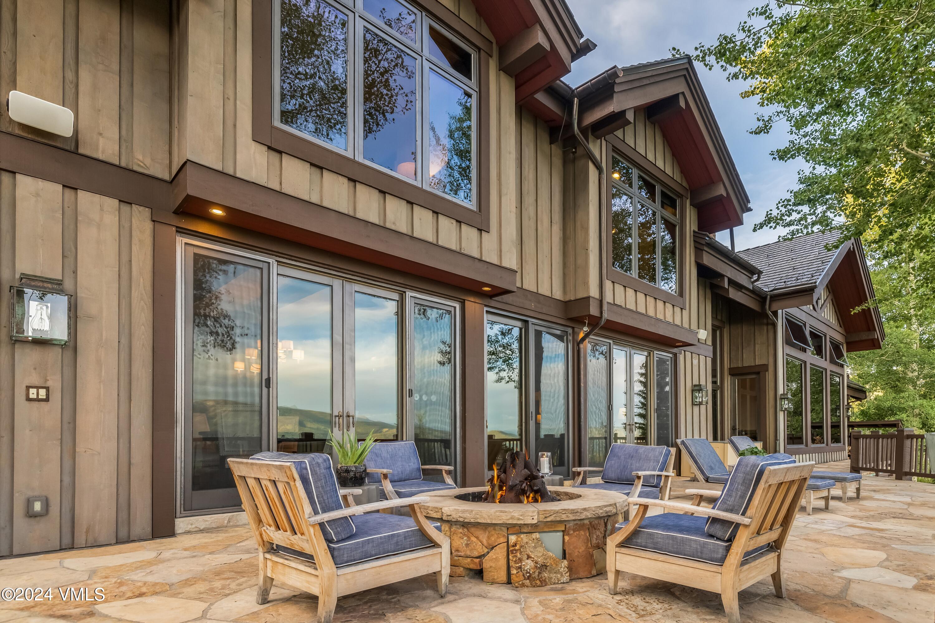 48 Jasmine Avon, CO 81620 - Photo 35 of 67 a view of a patio with couches table and chairs and floor to ceiling window