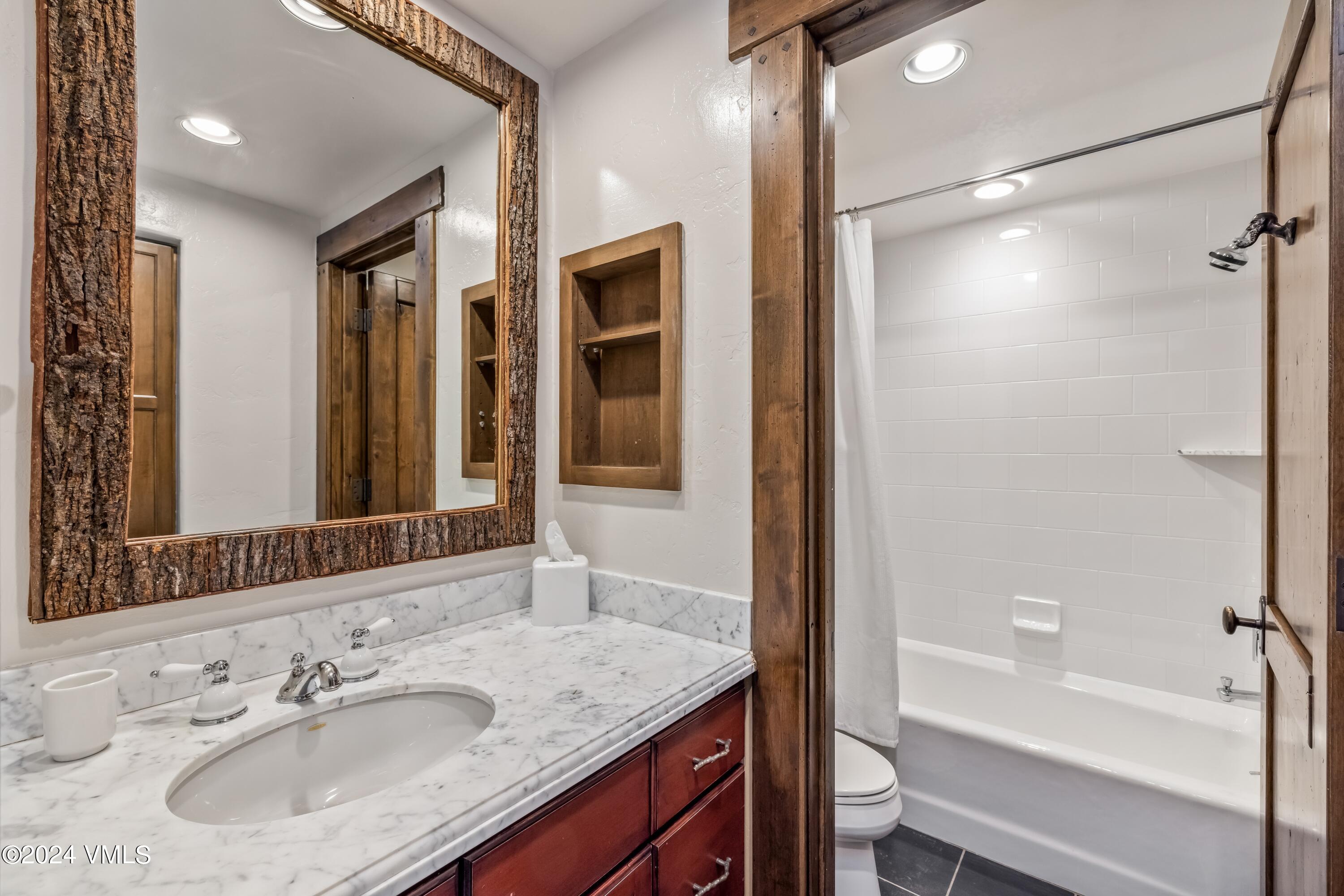 48 Jasmine Avon, CO 81620 - Photo 50 of 67 a bathroom with a granite countertop sink mirror and a bathtub