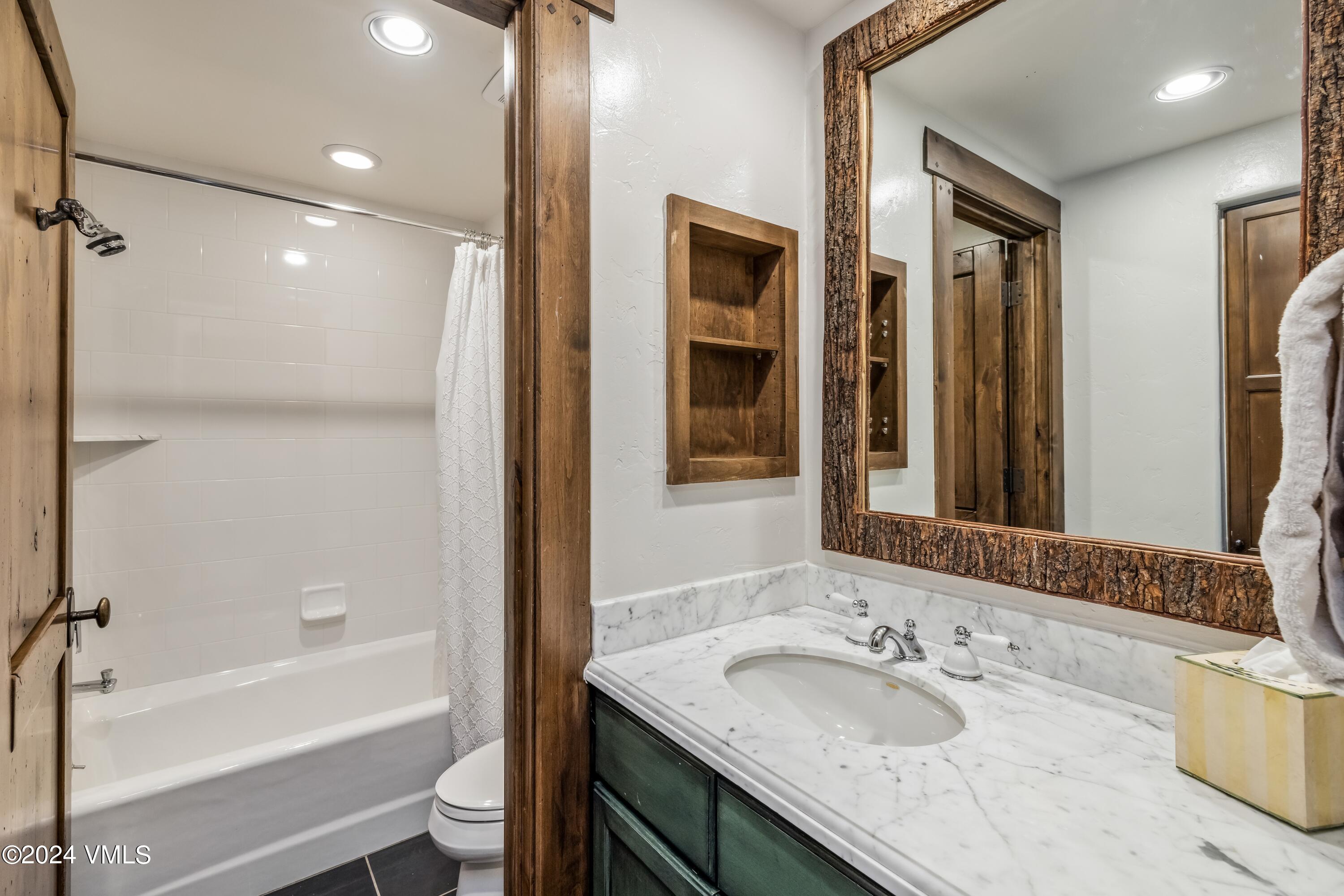 48 Jasmine Avon, CO 81620 - Photo 60 of 67 a bathroom with a granite countertop sink a toilet and shower