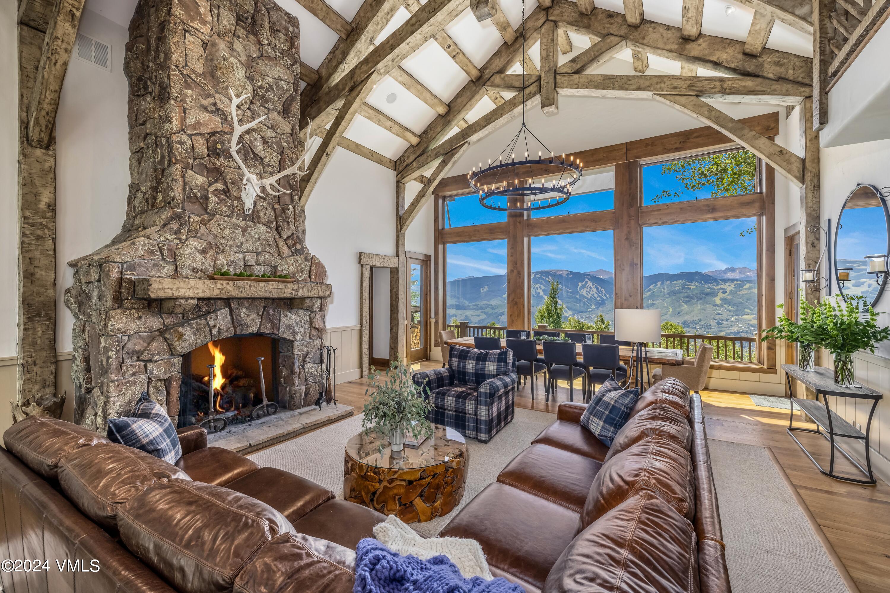 48 Jasmine Avon, CO 81620 - Photo 7 of 67 a living room with furniture a fireplace a floor to ceiling windows and a fireplace
