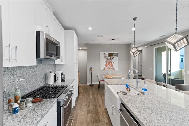 a kitchen with stainless steel appliances granite countertop a stove and a sink