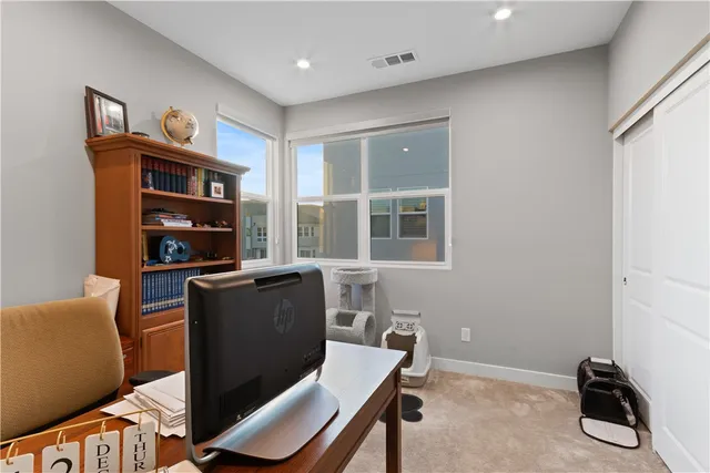 a kitchen with kitchen island a white counter top space a sink stainless steel appliances and cabinets