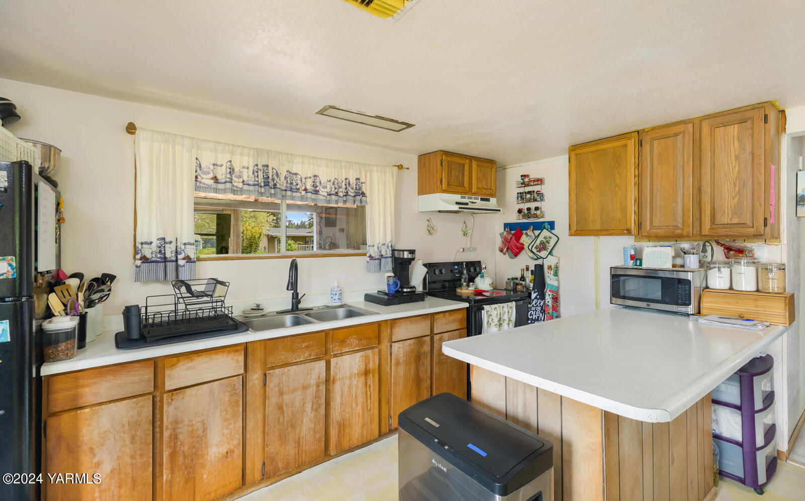 1690 Trails Road East Belfair, WA 98528 - Photo 18 of 22 a kitchen with stainless steel appliances a sink a stove a refrigerator cabinets and a counter top space