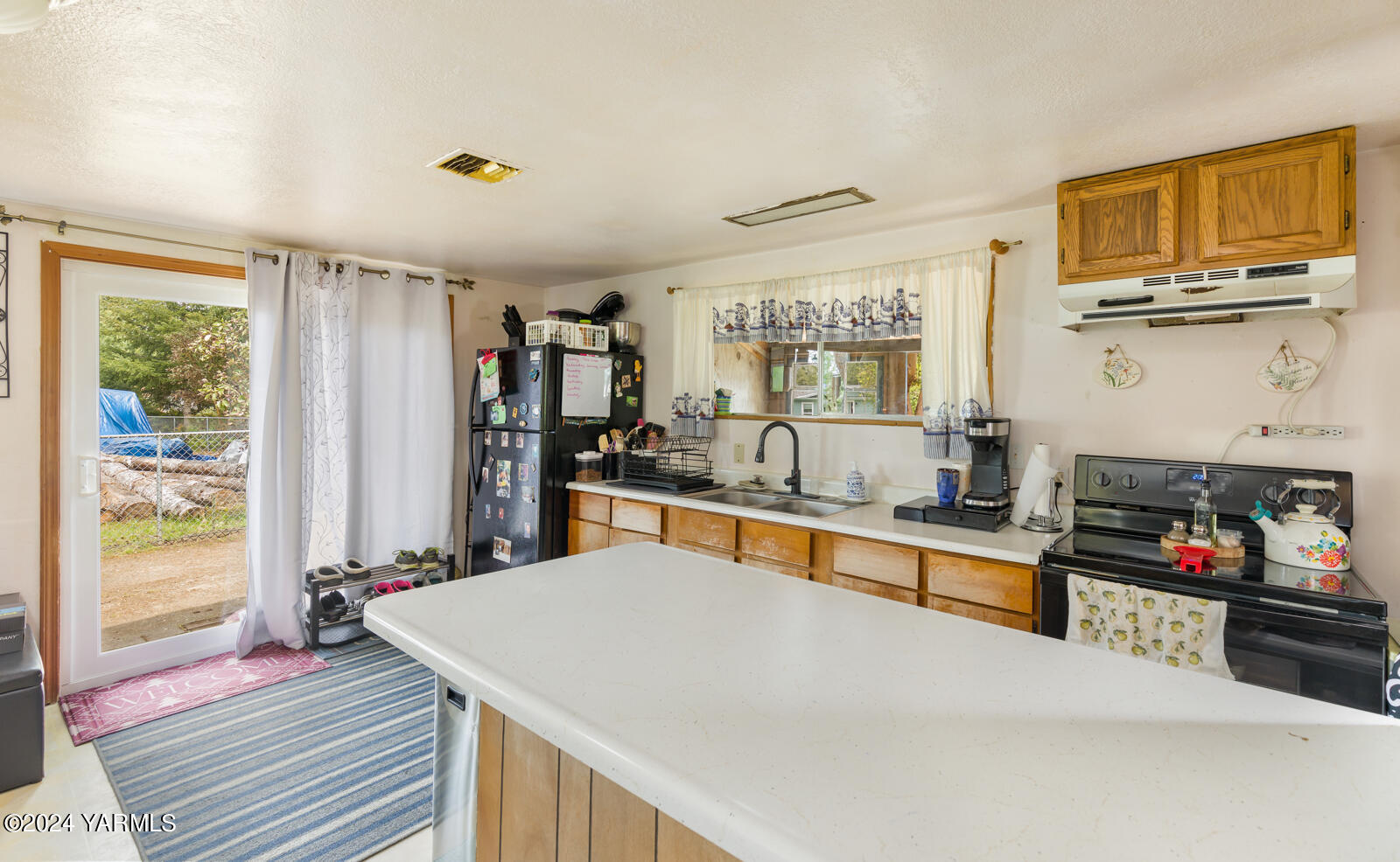 1690 Trails Road East Belfair, WA 98528 - Photo 19 of 22 a large kitchen with stainless steel appliances a large counter top a stove and a refrigerator