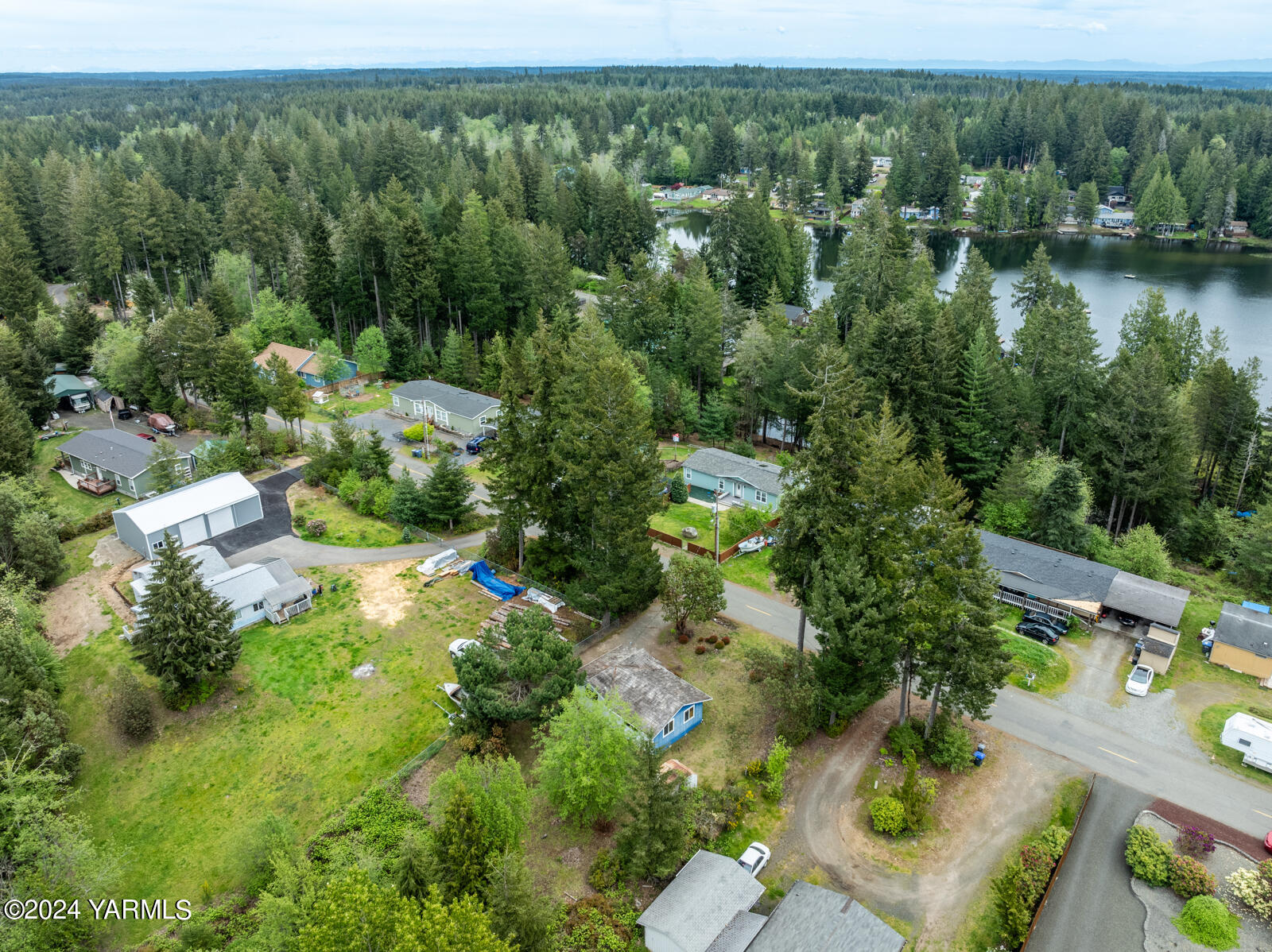 1690 Trails Road East Belfair, WA 98528 - Photo 4 of 22 an aerial view of green landscape with trees houses and mountain view